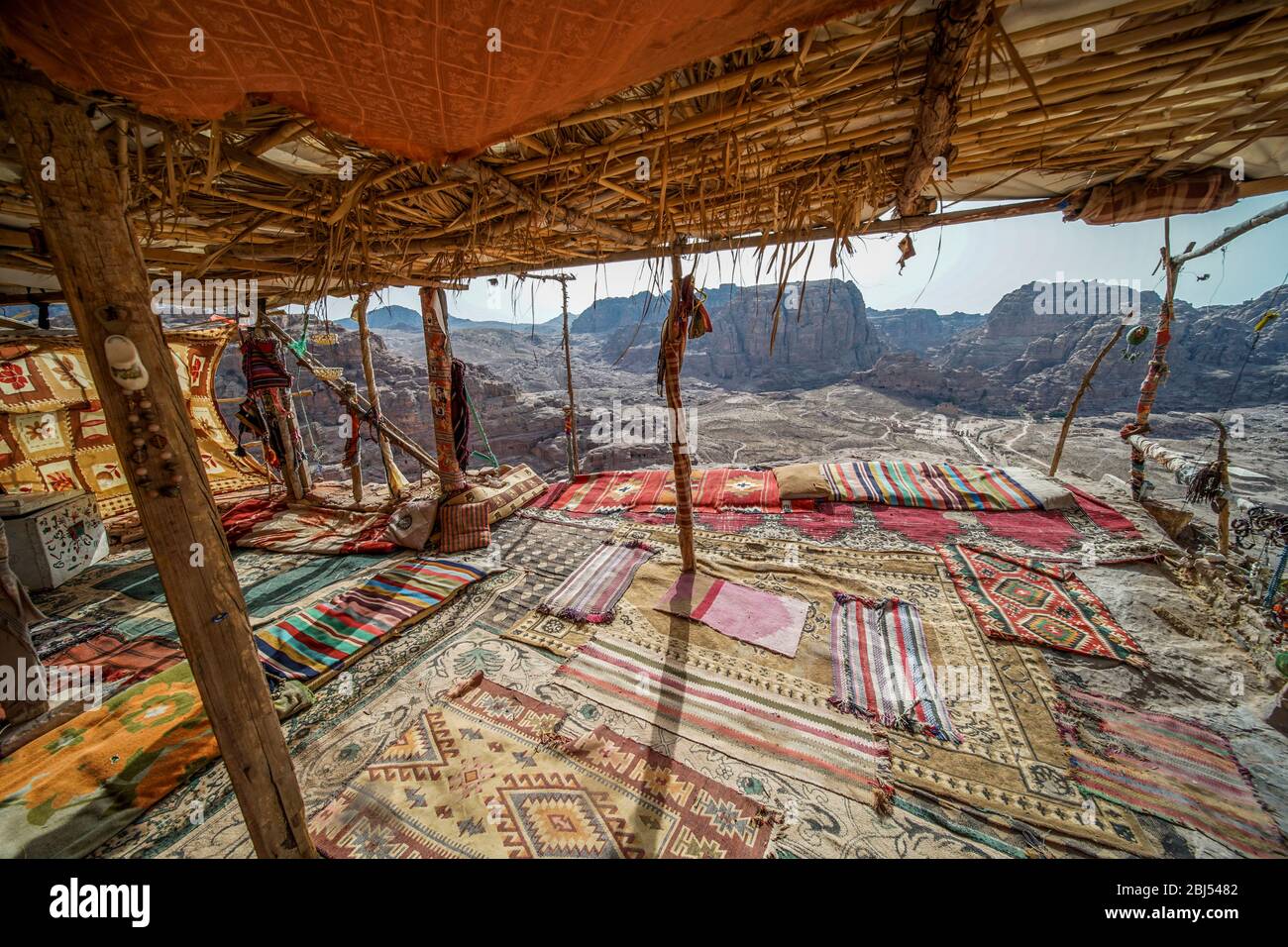 A colourful Bedouin dwelling outfitted with comfortable rugs overlooks the desert near Petra in Jordan. Stock Photo