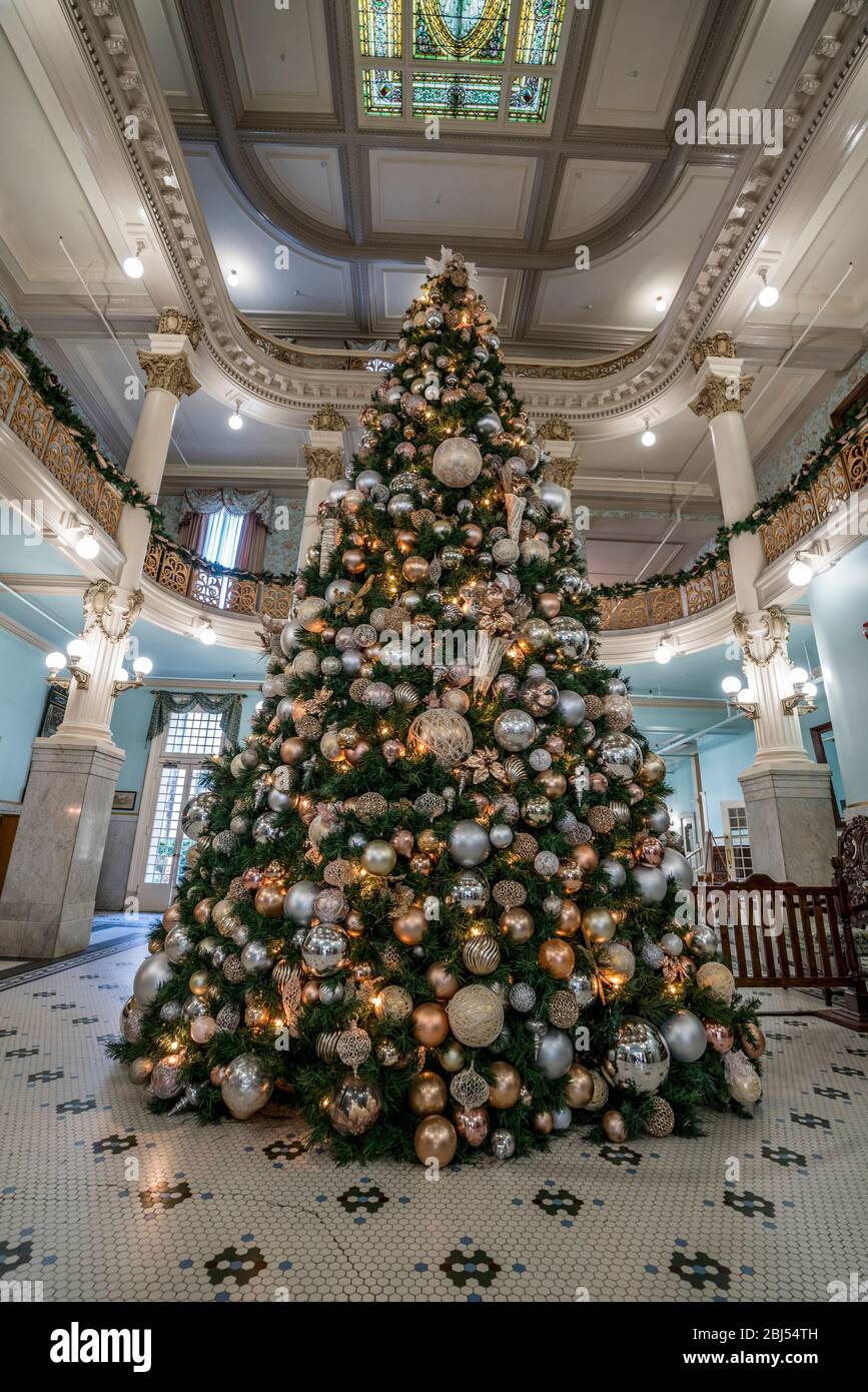 A Christmas tree brings festive warmth to the obby of an historic hotel in San Antonio in Texas Stock Photo