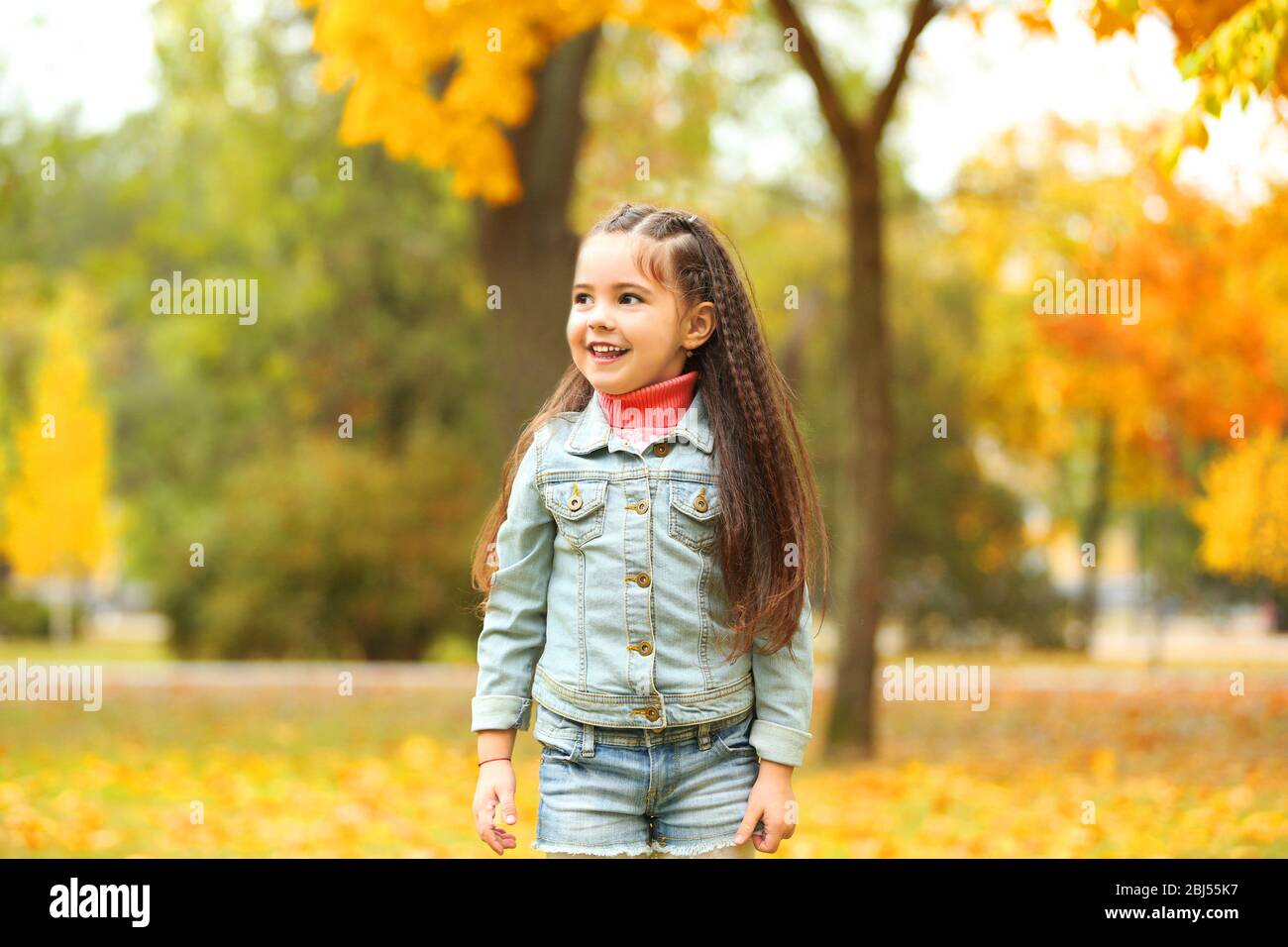 Cute girl playing with soap bubbles in park Stock Photo - Alamy
