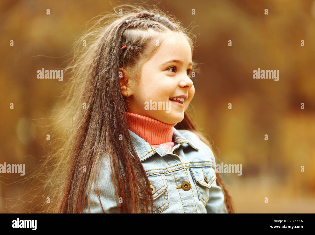 Cute girl playing with soap bubbles in park Stock Photo - Alamy