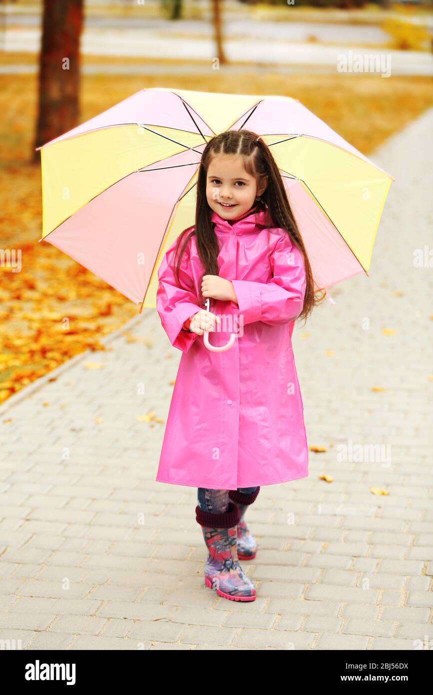 Beautiful little girl with umbrella in park Stock Photo - Alamy