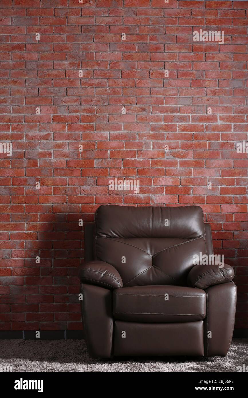 Brown Leather Chair On Brick Wall Background Stock Photo Alamy