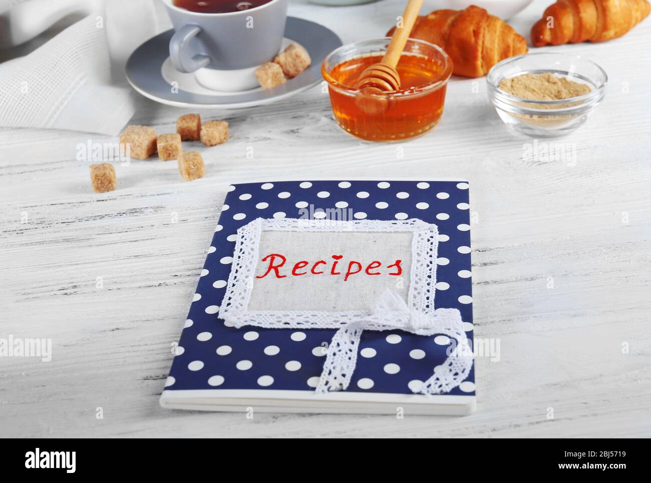 Comp Recipe Recipe book on a table with ingredients for baking Stock Photo - Alamy