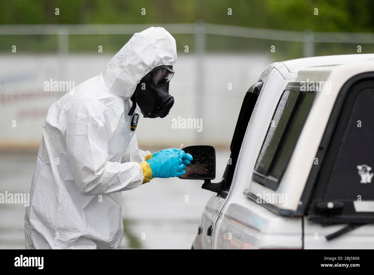 North Carolina National Guard soldiers take a swab sample from a worker at a COVID-19, coronavirus drive thru testing site for employees of Mountaire Farms food processing plant April 23, 2020 in Siler City, North Carolina. Stock Photo