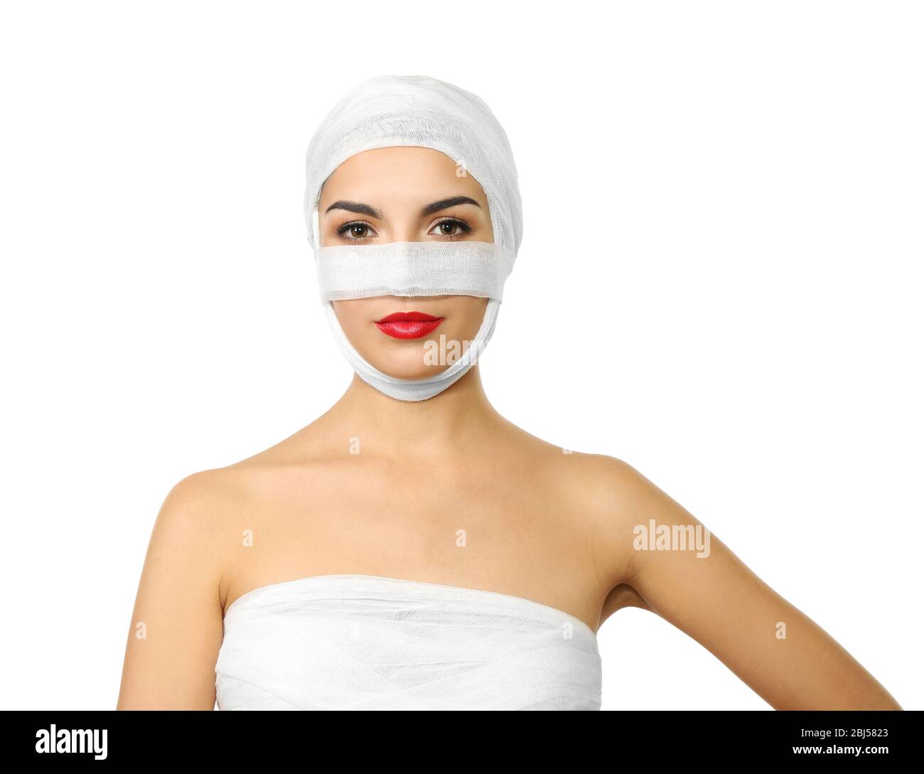 Young beautiful woman with a gauze bandage on her head and nose