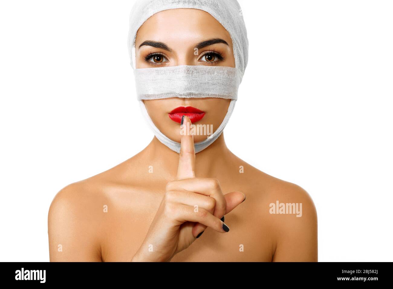Young beautiful woman with a gauze bandage on her head and nose