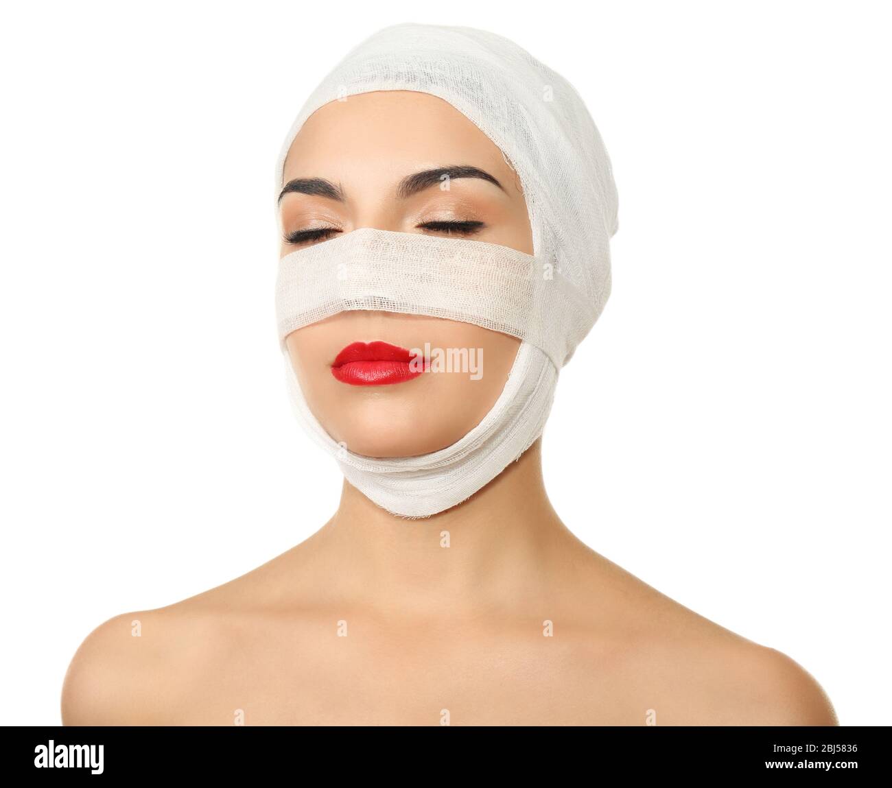 Young beautiful woman with a gauze bandage on her head and nose
