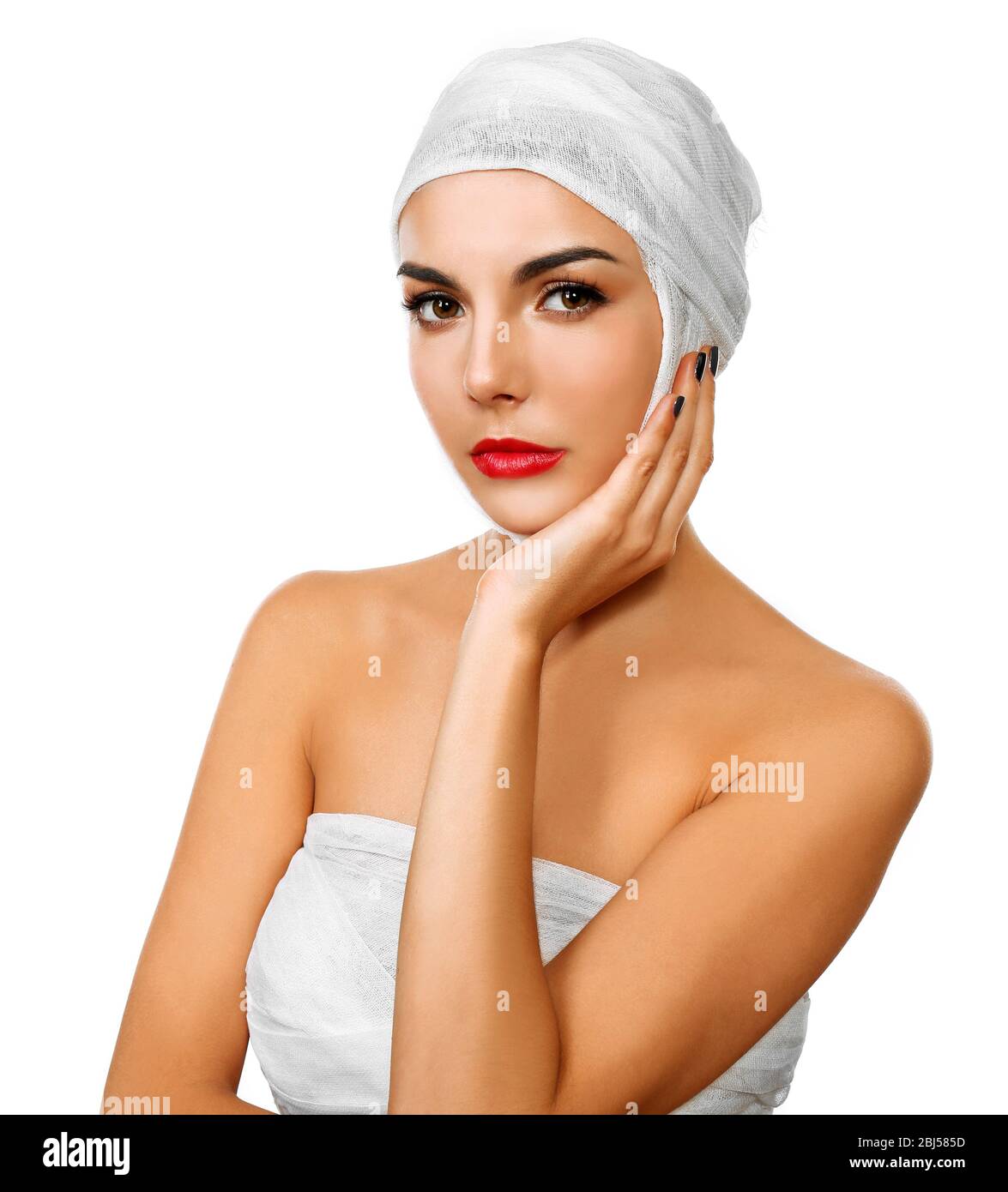 Foto de Doctor wrapping bandage around young woman's chest on white  background, closeup do Stock