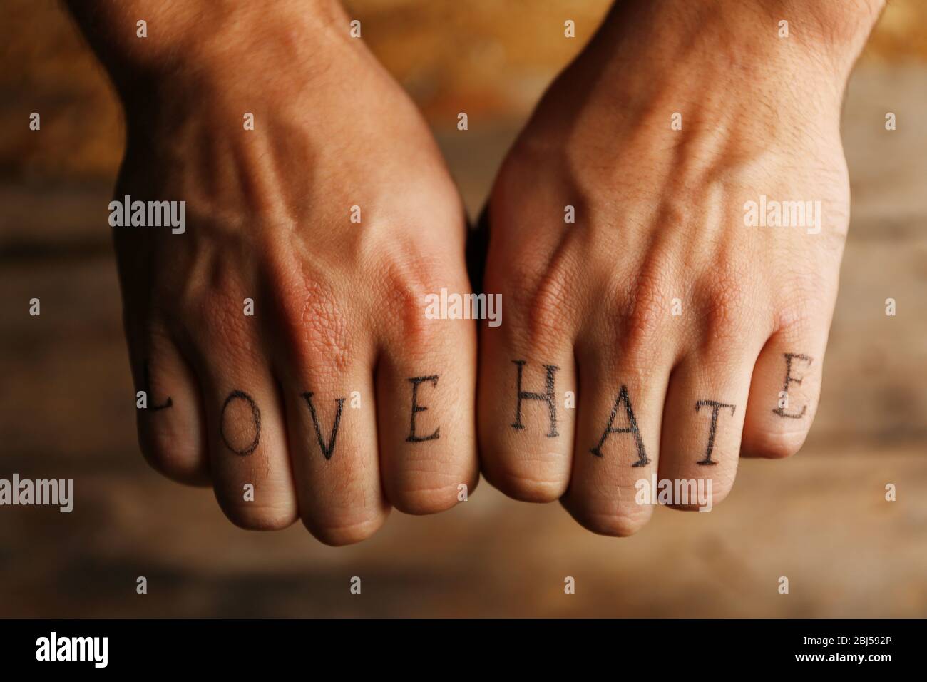 Tattoo inscriptions on male fingers drawn with marker Stock Photo