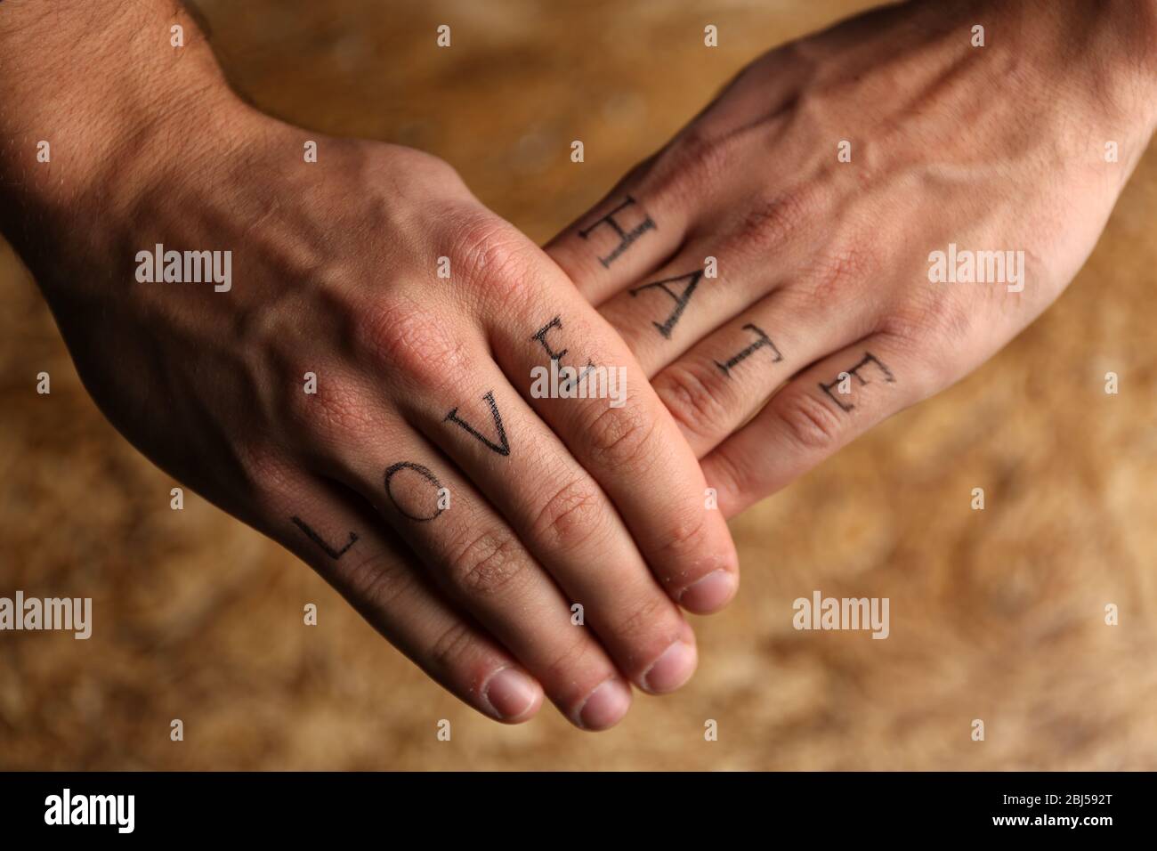 Tattoo inscriptions on male fingers drawn with marker Stock Photo