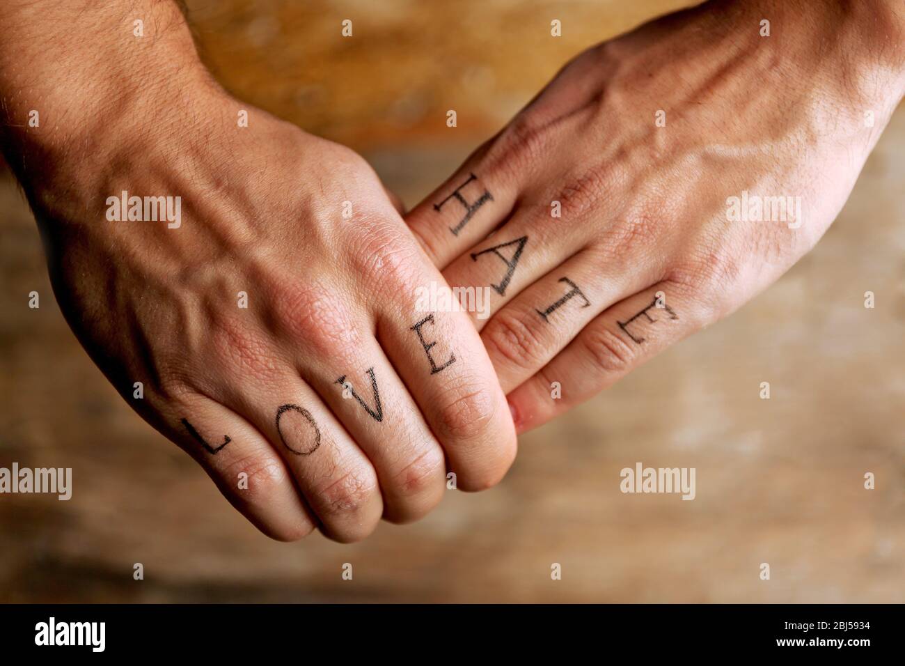 Tattoo inscriptions on male fingers drawn with marker Stock Photo