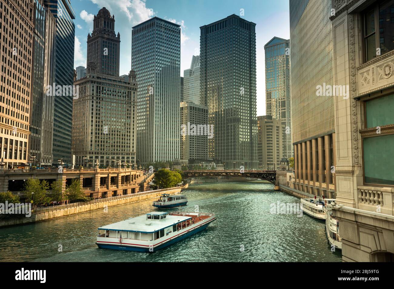 City buildings and skyline over the boats on the Chicago River Illinois ...
