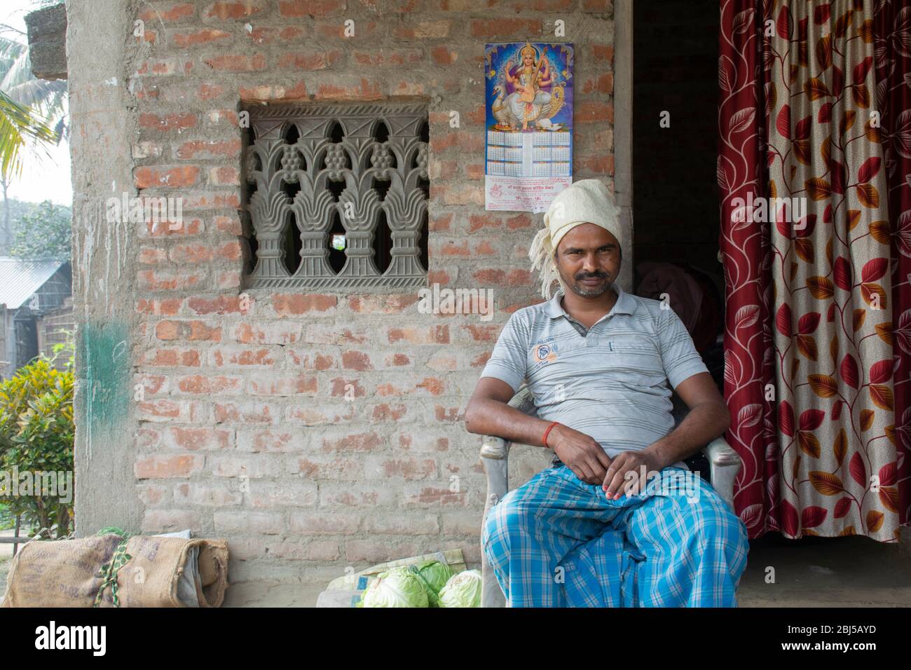 Portrait of rural Indian man sitting at door fo his house Stock Photo ...