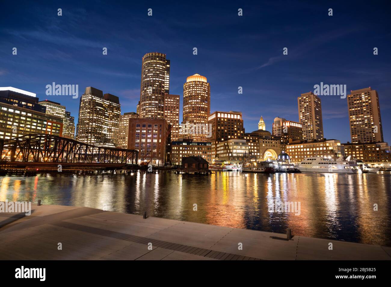 Downtown city view of Boston Massachusetts looking of the riverfront harbor at night Stock Photo