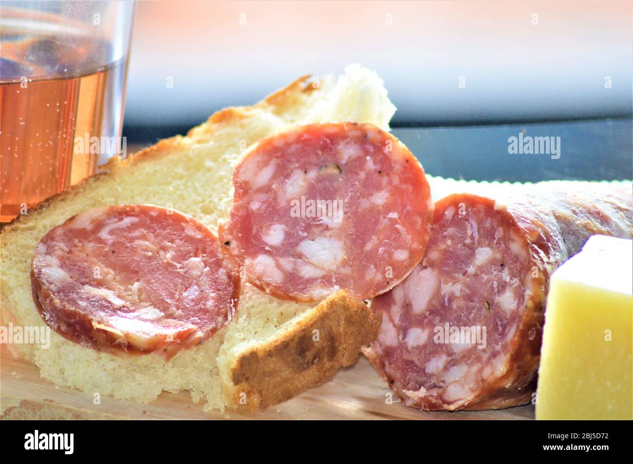 italian picnic food with salami sausage pork cheese wine bread Stock