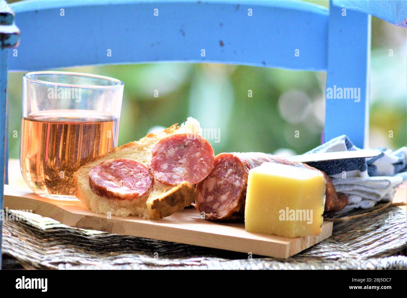 italian picnic food with salami sausage pork cheese wine bread Stock