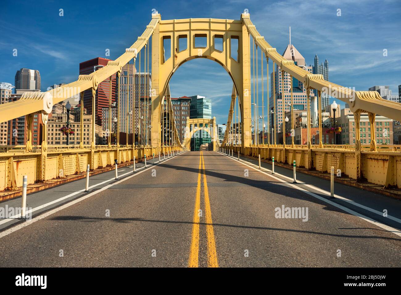 Traffic and people cross the Allegheny River on the Roberto Clemente Bridge in downtown Pittsburgh Pennsylvania USA Stock Photo