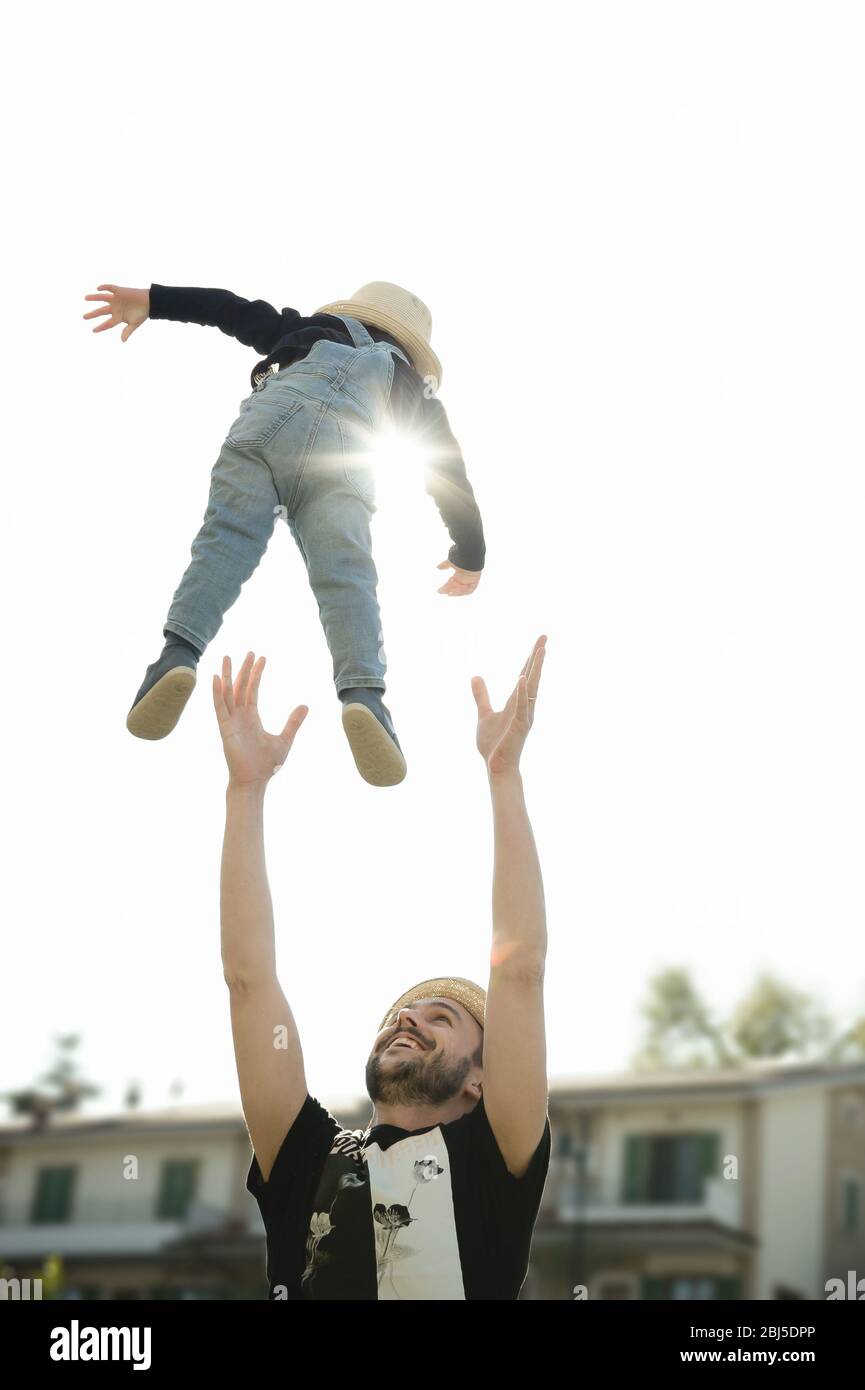 Staying at home a father and his young son playing together in the