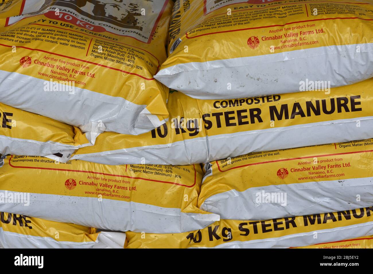 Ten kilo bags of steer manure for sale for fertilizing gardens Stock Photo