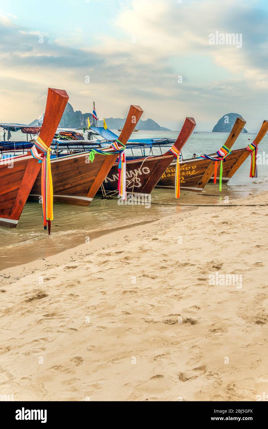 Thai Longtail Boats lined up at the Beach of Koh Ngai Island, Krabi, Thailand Stock Photo