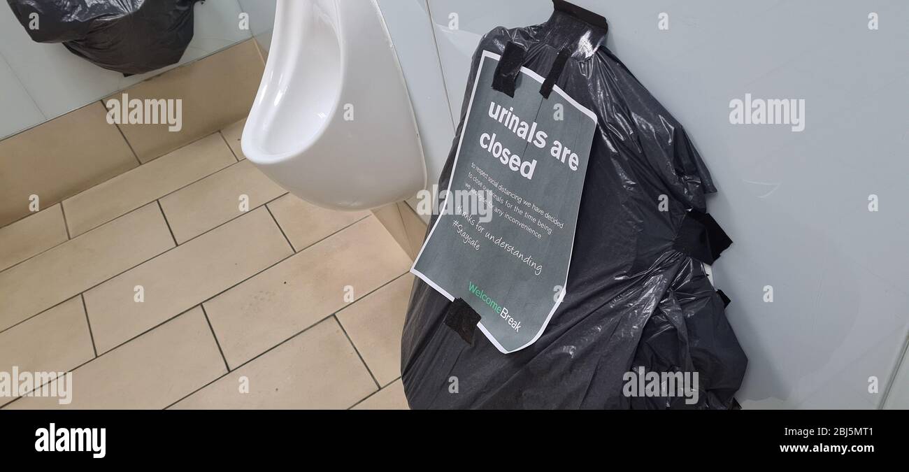 Birmingham, UK - 12th April 2020: Bin bags wrapped around urinals to prevent people standing to close during social distancing Stock Photo
