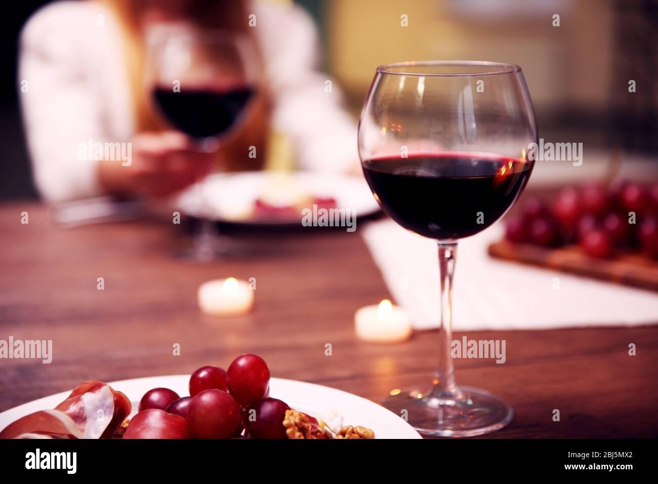 Glass with red wine on the table Stock Photo Alamy