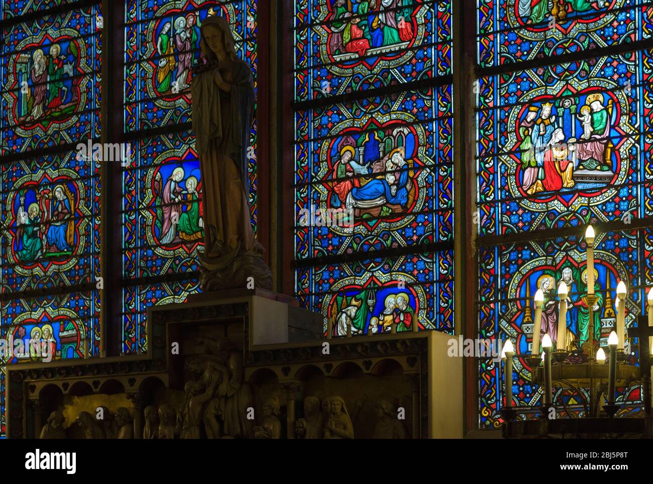 Stained glass in the catholic cathedral Notre-Dame de Paris. Built in French Gothic architecture, and it is among the largest and most well-known chur Stock Photo