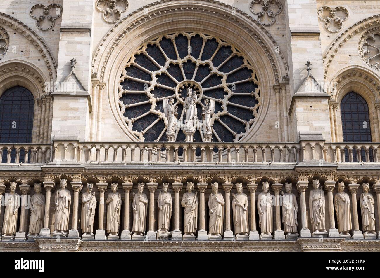 The western rose window, kings statues and architectural details of the catholic cathedral Notre-Dame de Paris. Built in French Gothic architecture, a Stock Photo