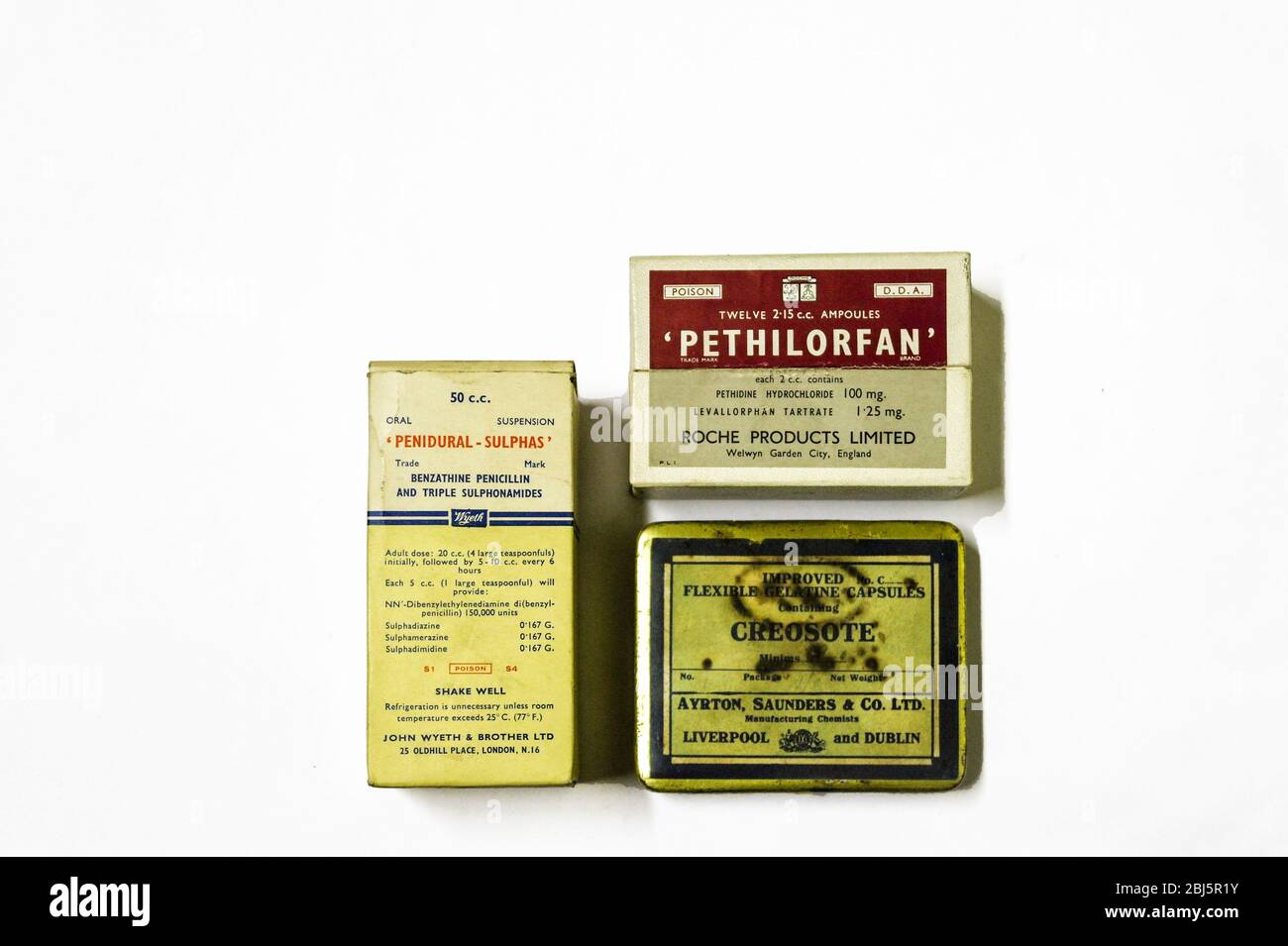 Old packets of Penidural Sulphas penicillin, Pethilorfan opioid antagonis labelled poison and a packet of Gelatine capsules. Stock Photo