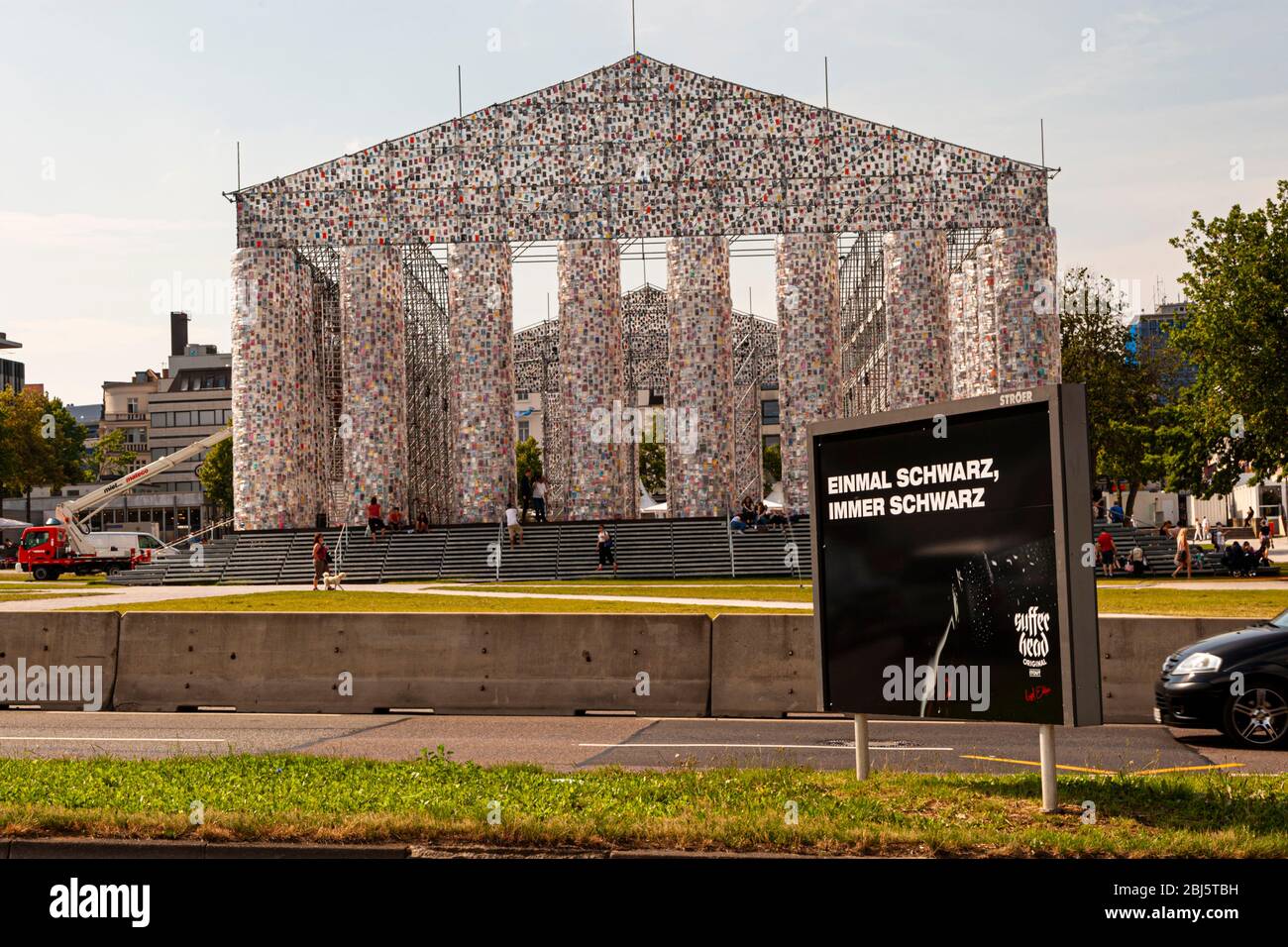 Advertisement for a black beer in front of Parthenen of Books at Documenta 2017 in Kassel, Germany. The Argentine artist Marta Minujin has erected countless books about a Parthenon on a scaffold Stock Photo