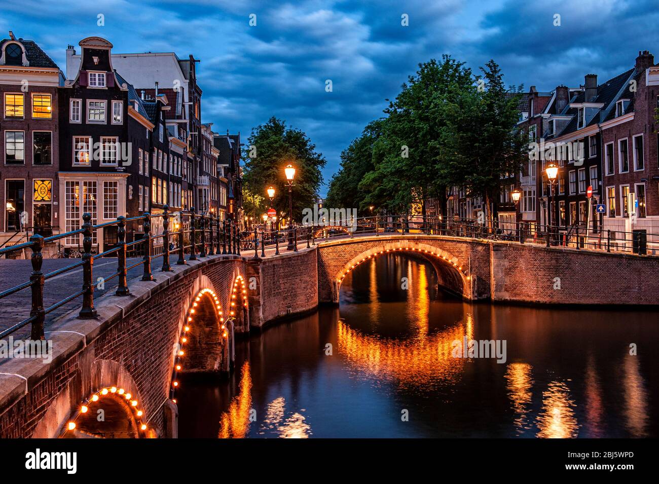 Amsterdam, Netherlands. Seven bridges. Keizersgracht and Reguliersgracht canals, illuminated with the small lights reflecting on the river Stock Photo