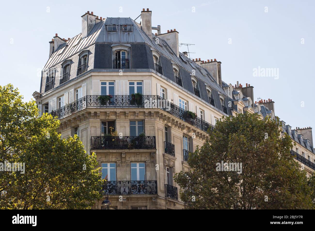 Typical design of Parisian architecture. The facade of french building in modern style with windows and french balconies in Paris, France. Stock Photo