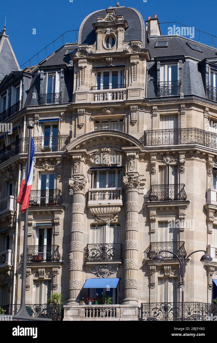 Typical design of Parisian architecture. The facade of french building in modern style with windows and french balconies in Paris, France. Stock Photo