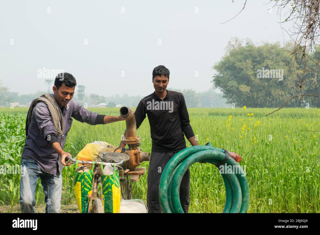 Indian farmer with water pump Stock Photo