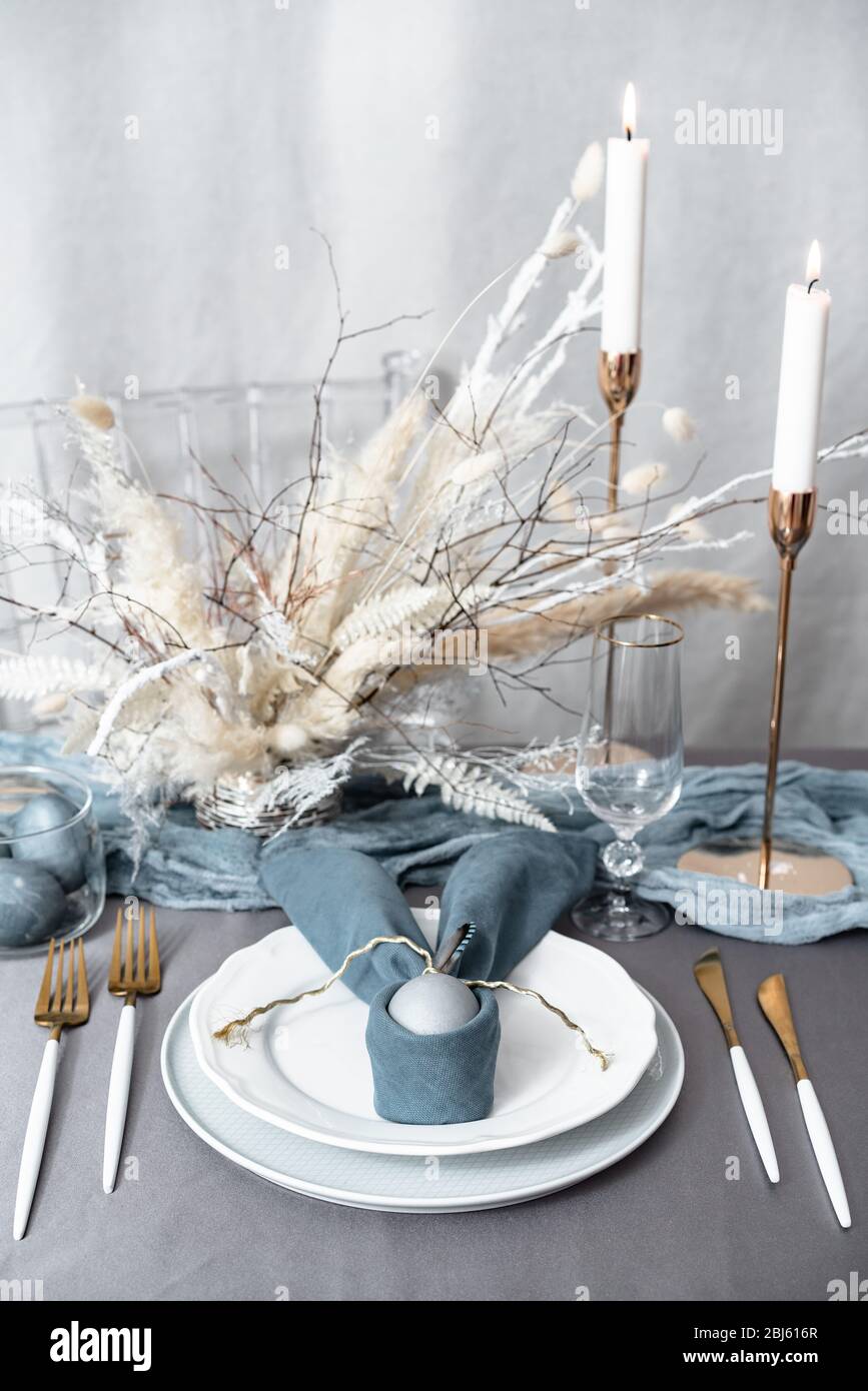 Setting easter table with candles and colored eggs Stock Photo