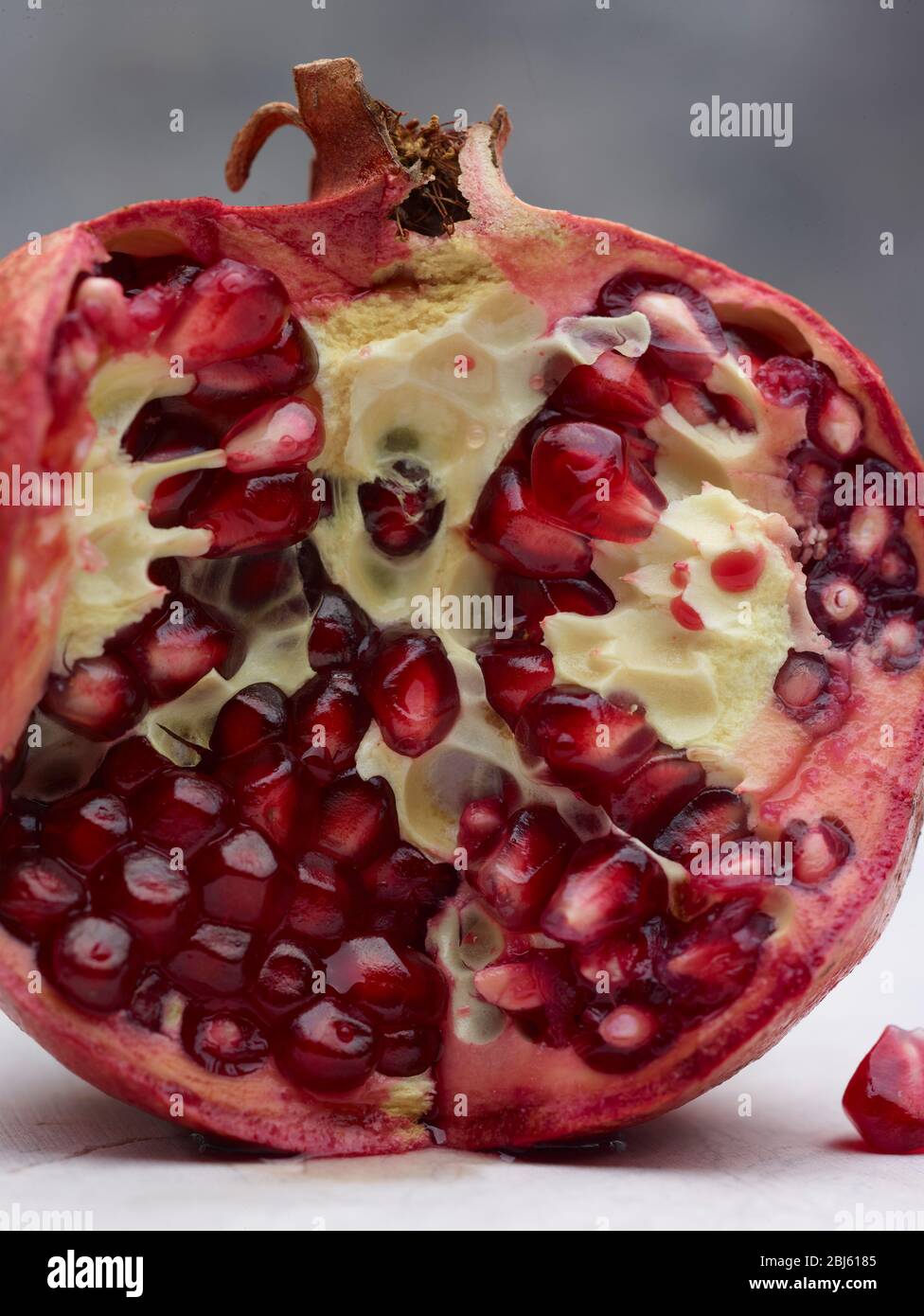 Still-life of Pomegranate and seeds depiction, natural fruit portrait Stock Photo