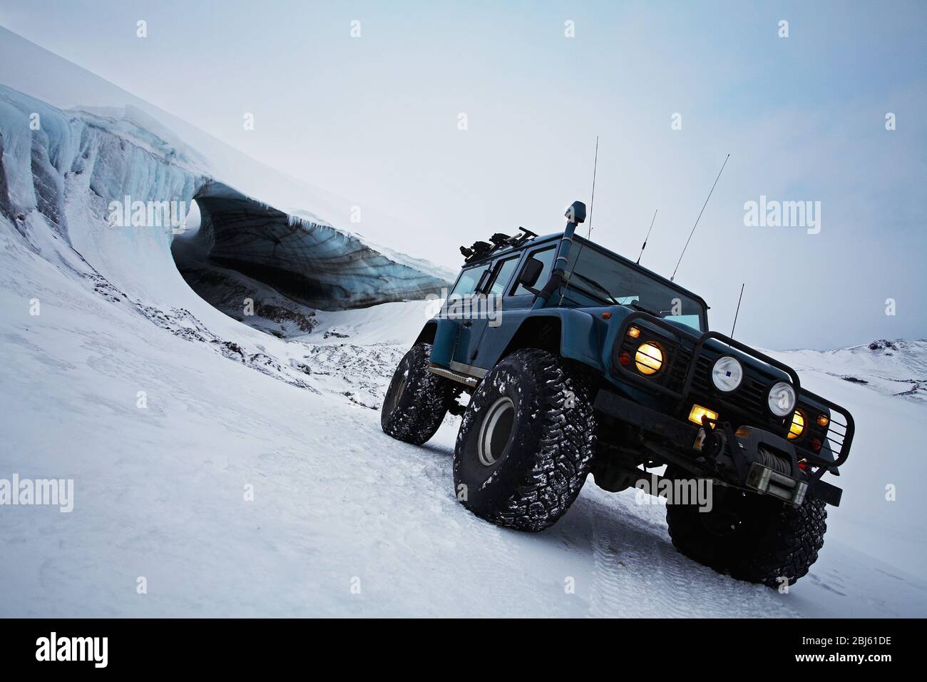 customised SUV standing in front of glacial ice cave on glacier Stock ...