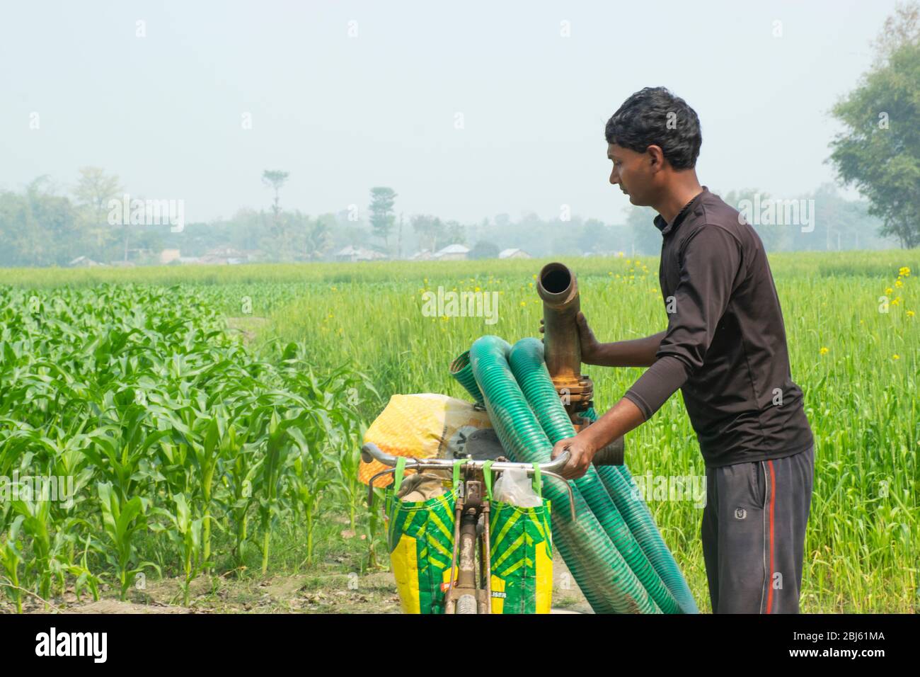 Indian farmer with water pump Stock Photo