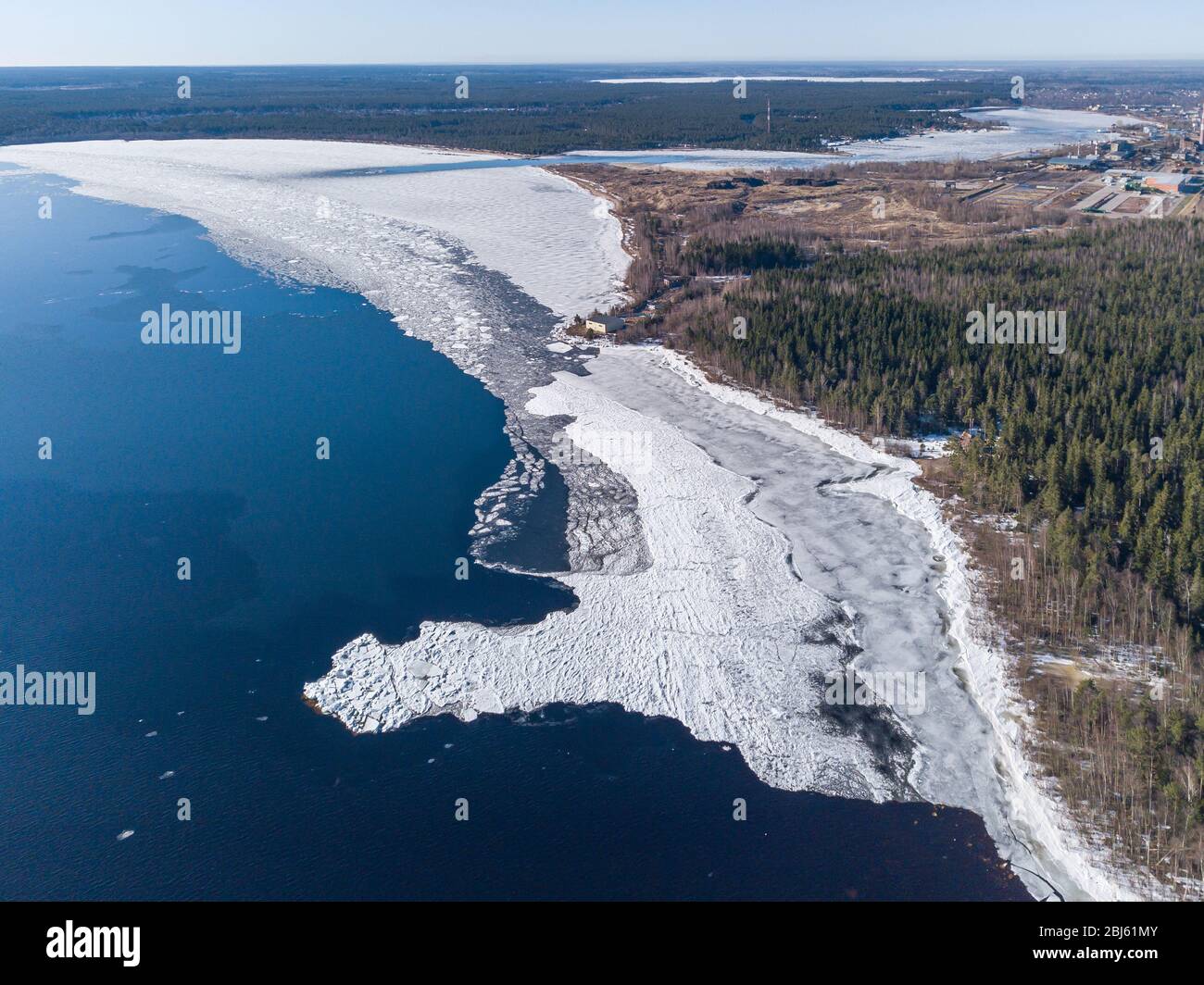 Aerial view of the shoreline of the lake and pieces of melting ice along the shore Stock Photo