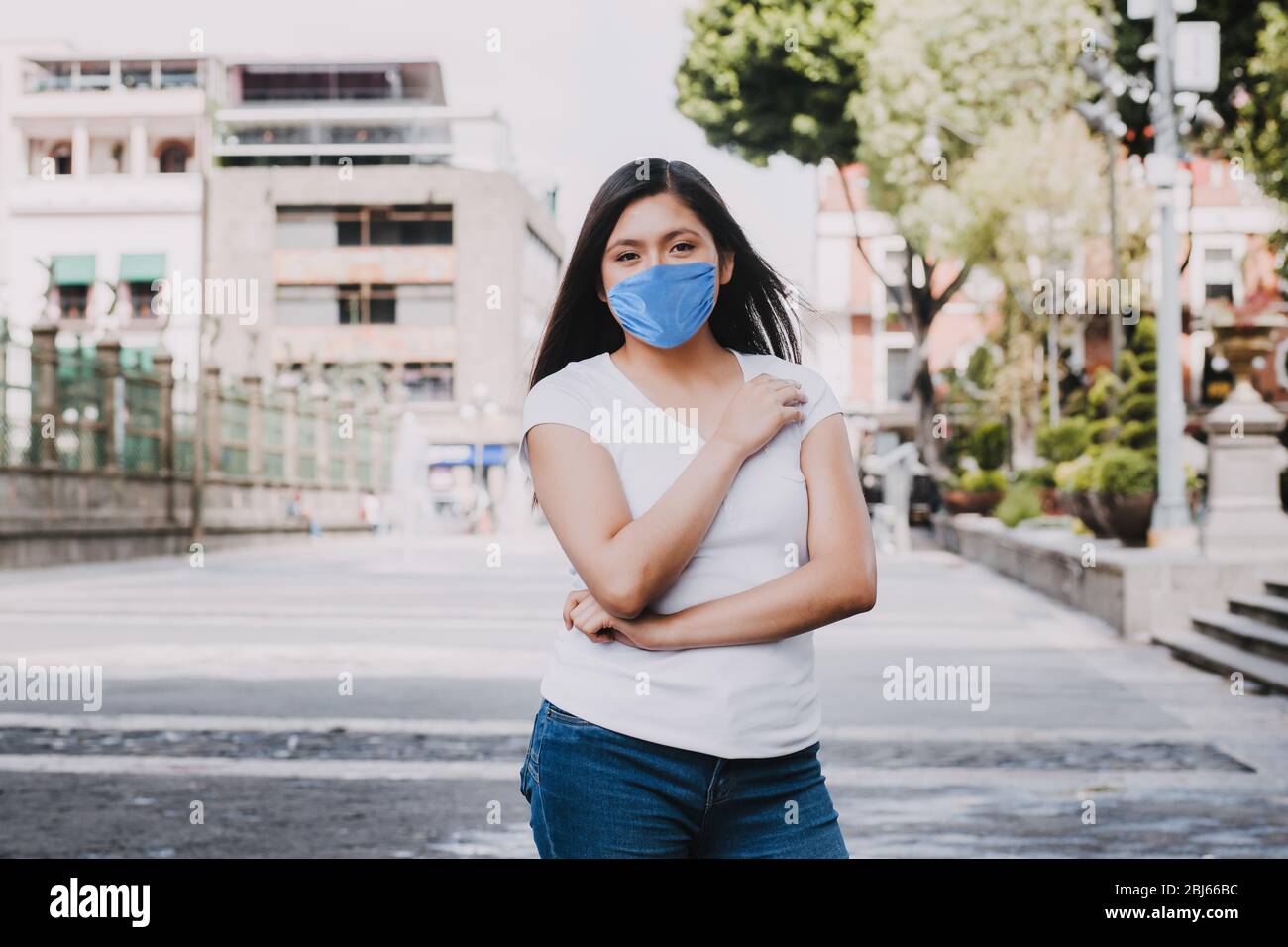 hispanic woman wearing mask face to prevent infection or respiratory illness, Mexican man with Protection against contagious coronavirus in Mexico Lat Stock Photo