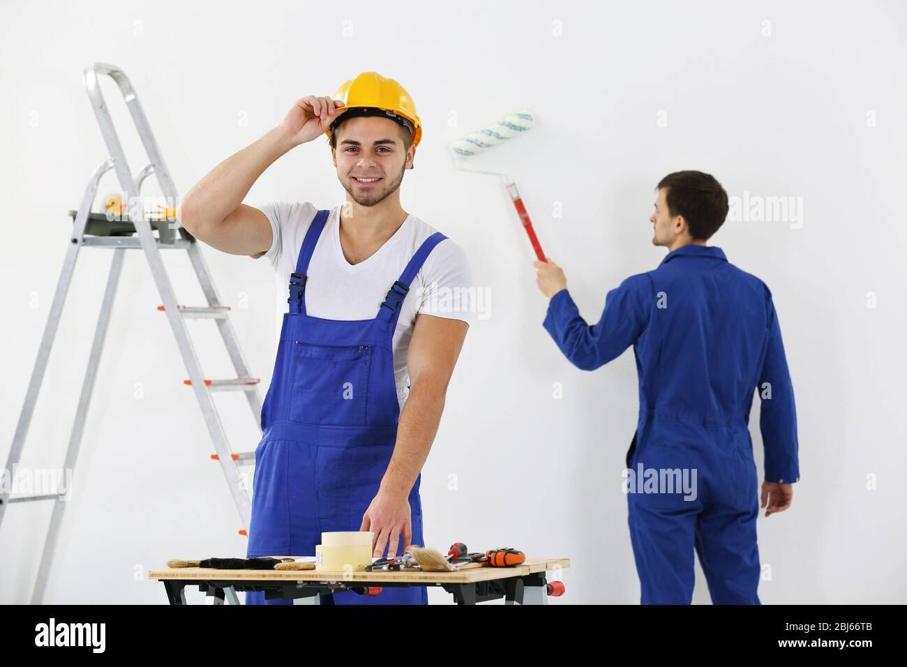 Workers in apartment Stock Photo Alamy