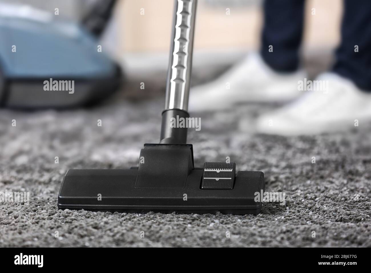 Cleaning concept - woman cleaning the room with carpet sweeper, close ...