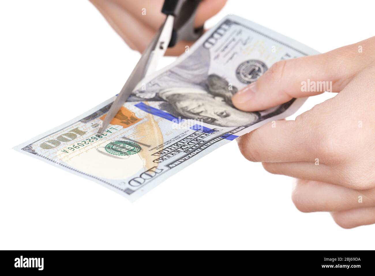 Hands with scissors cutting dollar banknote, isolated on white Stock ...