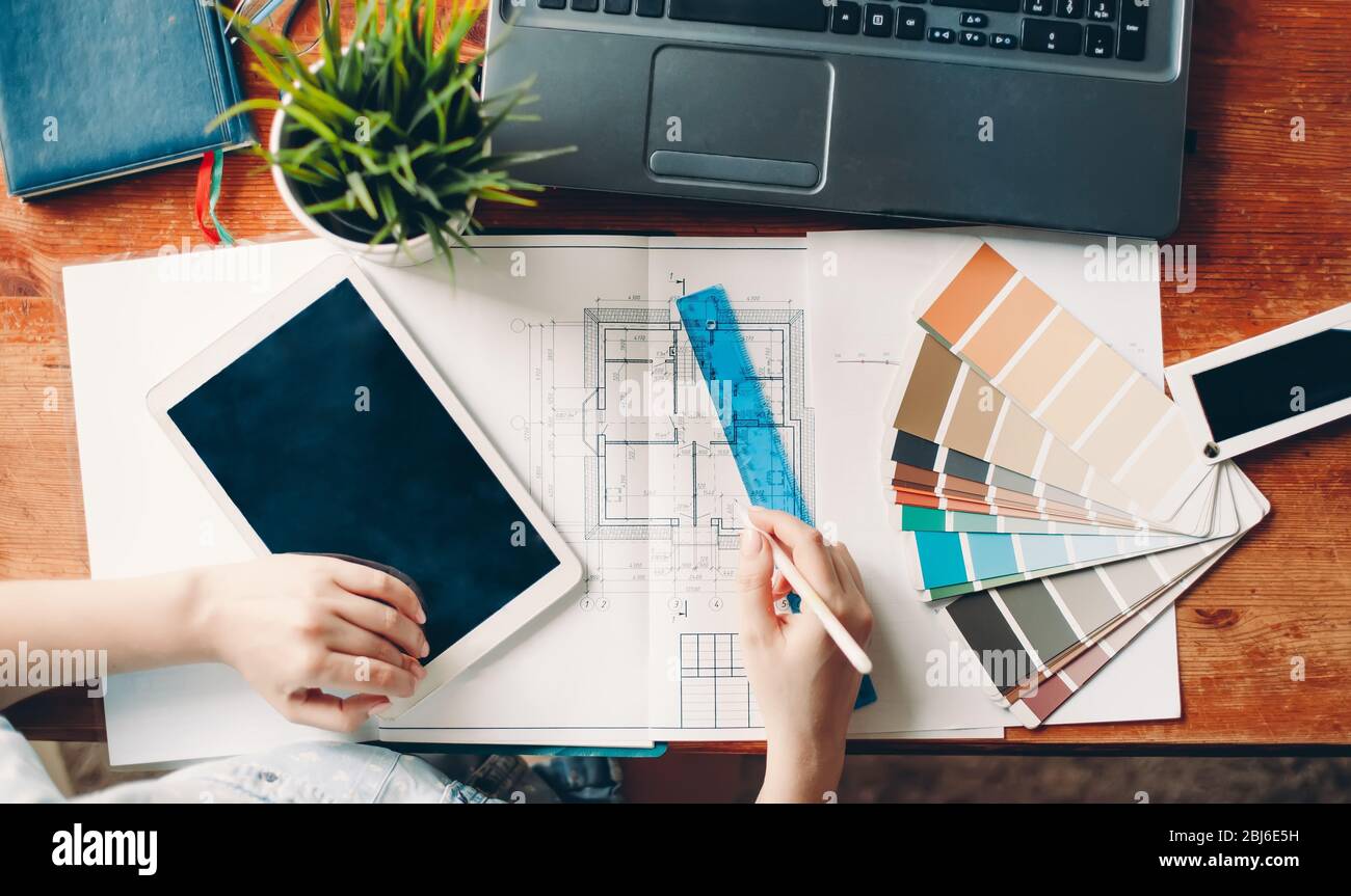 The desktop of the interior designer, the architectural plan of the ...