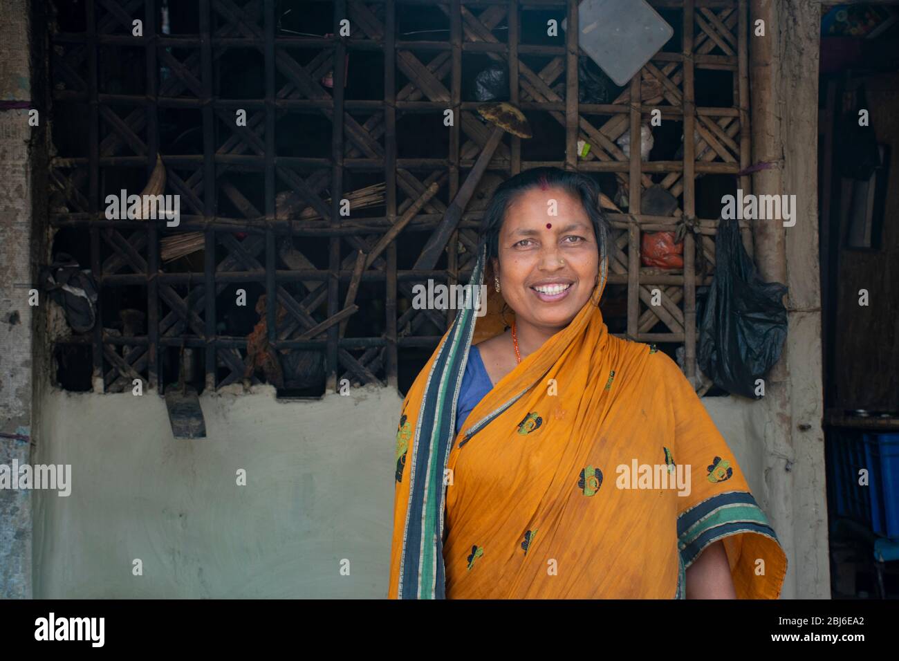 Rural woman standing in front of house in her village. India Stock ...