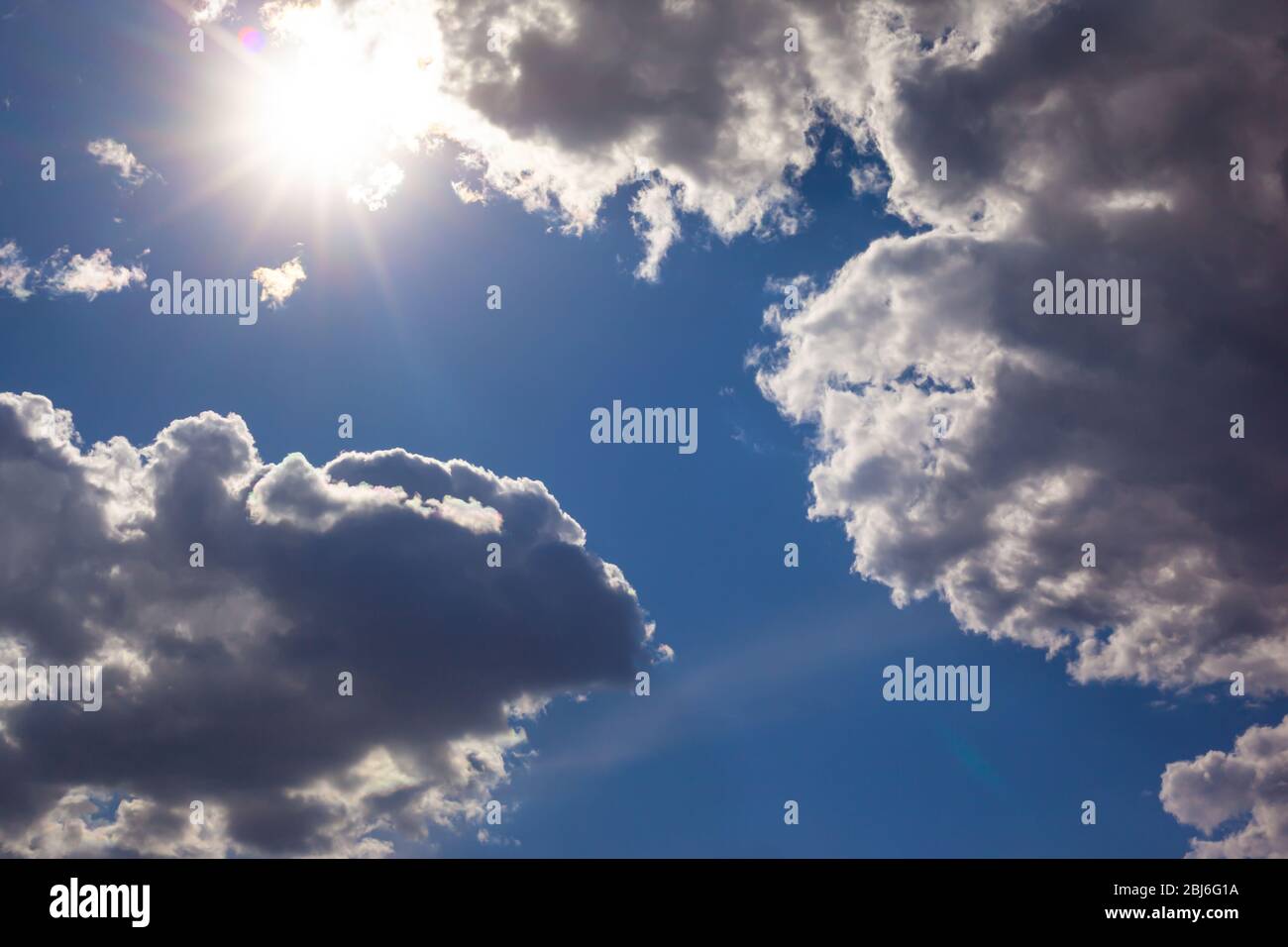 blue sky with white clouds and with the shining sun Stock Photo - Alamy