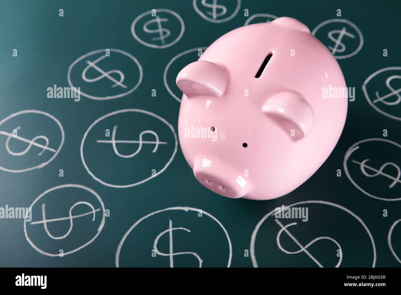 Piggy bank on a chalkboard with Dollar currency symbols Stock Photo - Alamy