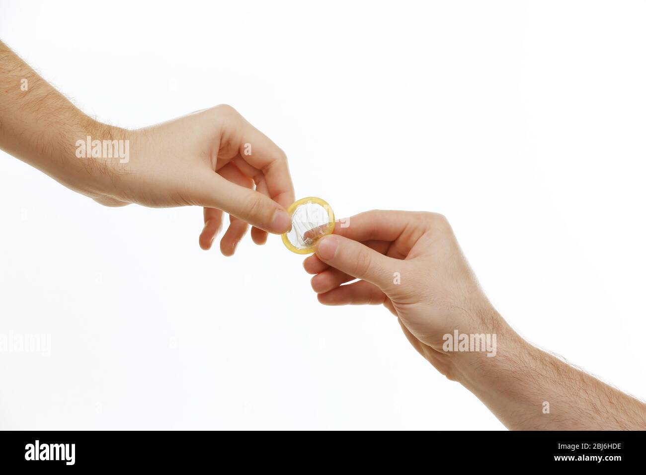 One man giving a condom to another man isolated on white Stock Photo Alamy