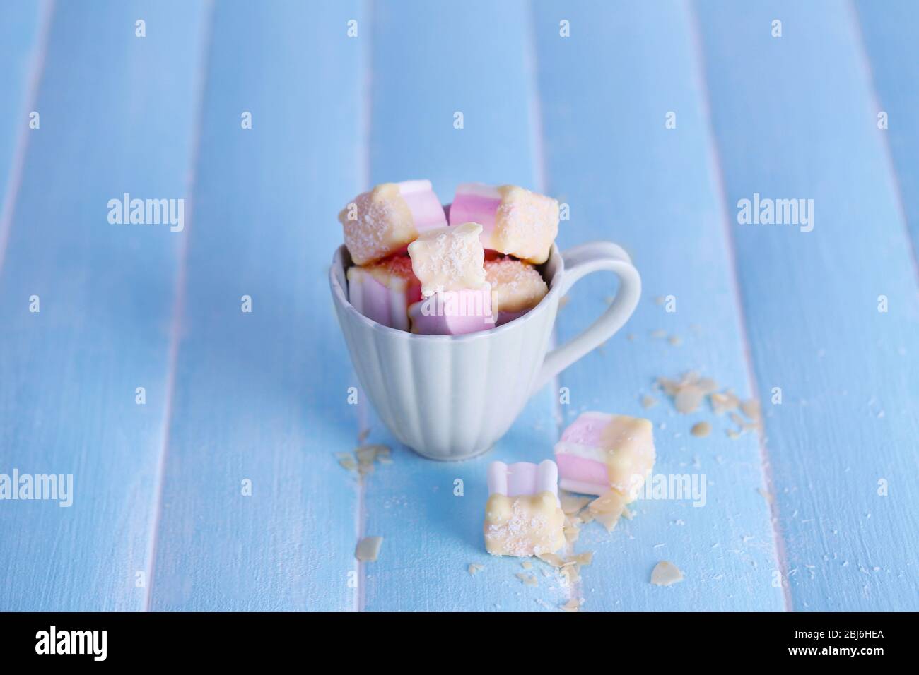 Tasty marshmallows with chocolate in cup on table, close up Stock Photo