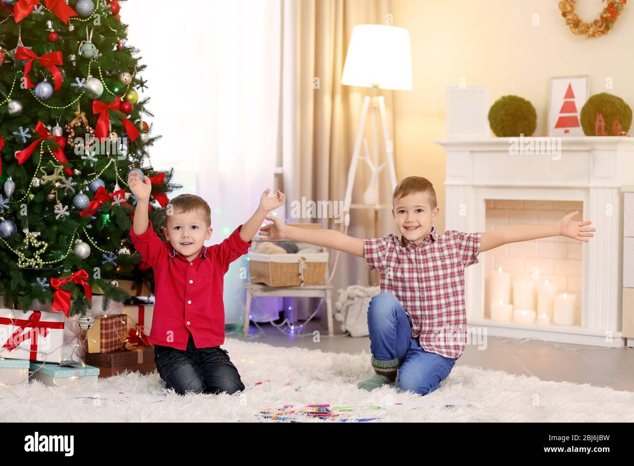 Two cute small happy brothers on Christmas tree background Stock Photo ...